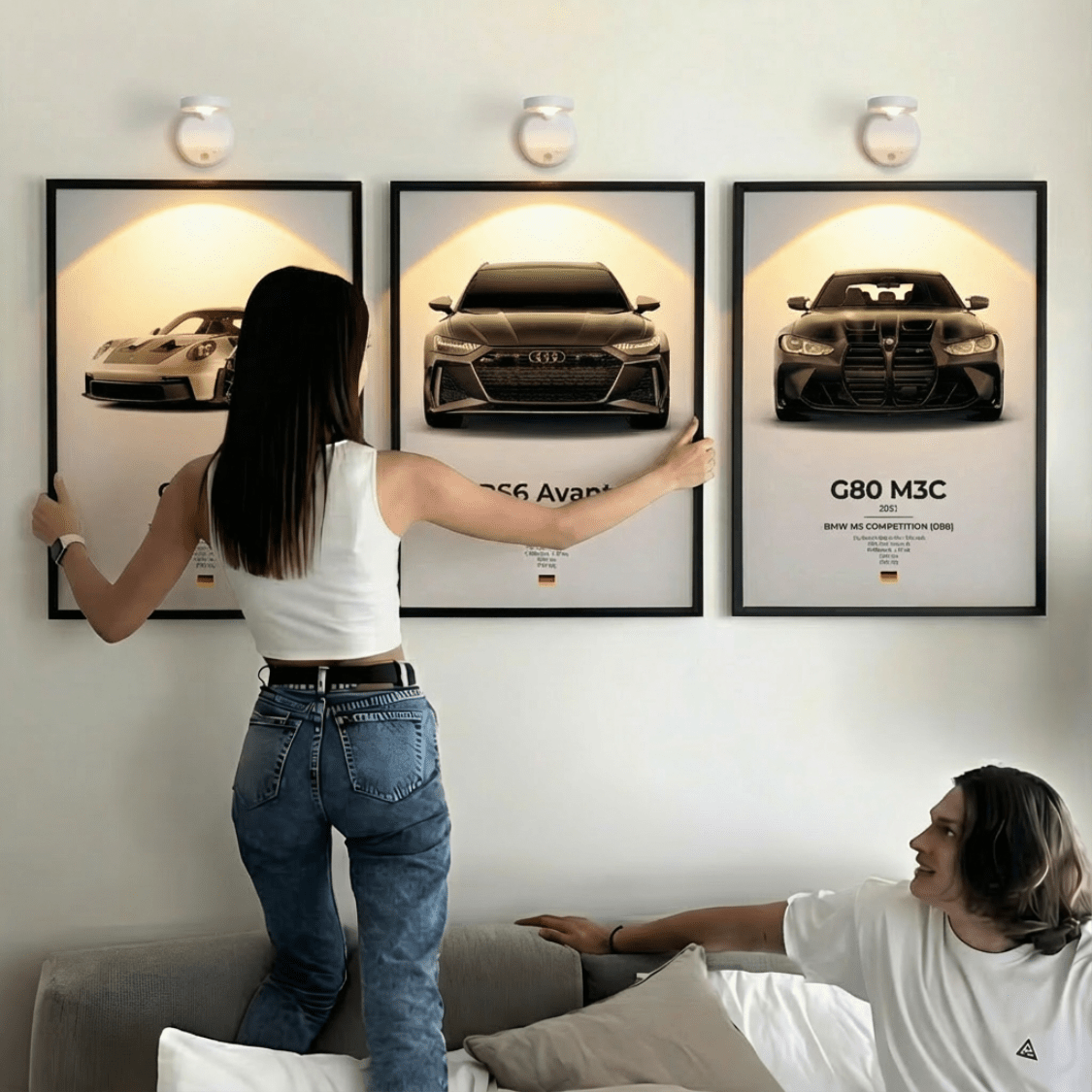 Car Artistry posters on a living room wall